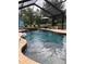 Relaxing screened pool featuring an attached spa for ultimate leisure at 15348 Glossy Ibis Rd, Weeki Wachee, FL 34614