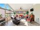 Sunroom with large windows offering serene outdoor views and a comfortable seating arrangement at 15348 Glossy Ibis Rd, Weeki Wachee, FL 34614