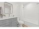 Bright bathroom with white vanity, modern fixtures, and shower-tub combo at 1713 W Saint John St, Tampa, FL 33607