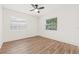 Empty bedroom with hardwood floors, ceiling fan, and two windows to provide natural light at 1713 W Saint John St, Tampa, FL 33607