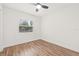Bedroom featuring ceiling fan, wood-look flooring, and a bright window at 1713 W Saint John St, Tampa, FL 33607