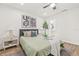 Bedroom with a queen bed, bedside tables, decorative art, and view into en-suite bathroom at 1713 W Saint John St, Tampa, FL 33607