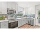 Updated kitchen with modern appliances, stylish backsplash, and plenty of natural light at 1713 W Saint John St, Tampa, FL 33607