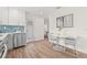Modern kitchen area features stainless steel appliances and a small dining table at 1713 W Saint John St, Tampa, FL 33607