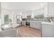 Bright kitchen featuring new stainless steel appliances, white cabinets, and a charming breakfast nook at 1713 W Saint John St, Tampa, FL 33607