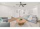Spacious living room with wood-look floors, ceiling fan, and comfortable gray seating at 1713 W Saint John St, Tampa, FL 33607