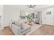 Inviting living room with wood-look floors, large window, gray seating, and modern decor at 1713 W Saint John St, Tampa, FL 33607