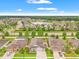 An aerial view of the neighborhood with lush landscaping and a tranquil lake at 18620 Rococo Rd, Spring Hill, FL 34610