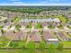 An aerial view of the neighborhood with beautiful landscaping and a scenic lake at 18620 Rococo Rd, Spring Hill, FL 34610