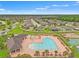 An aerial view of the community pool, basketball court and clubhouse at 18620 Rococo Rd, Spring Hill, FL 34610