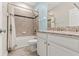 Bathroom features a granite countertop, tile flooring, and shower-tub combo at 18620 Rococo Rd, Spring Hill, FL 34610
