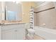 Bright bathroom features a granite countertop, tile flooring, and shower-tub combo at 18620 Rococo Rd, Spring Hill, FL 34610