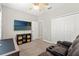 Comfortable bedroom features a ceiling fan, TV, and large closet at 18620 Rococo Rd, Spring Hill, FL 34610