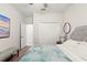 Relaxing bedroom with large closet, ceiling fan, and neutral carpet at 18620 Rococo Rd, Spring Hill, FL 34610