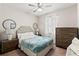 Inviting bedroom features a tufted headboard, ceiling fan, and natural light at 18620 Rococo Rd, Spring Hill, FL 34610