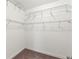 Empty walk-in closet featuring white walls, shelves, and neutral carpeted flooring at 18620 Rococo Rd, Spring Hill, FL 34610