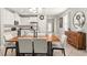Dining room area with a modern table, chandelier, and an adjacent view of the kitchen and living area at 18620 Rococo Rd, Spring Hill, FL 34610