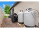 Outdoor setup featuring a grill, propane tanks, brick patio, and a view of the home's exterior at 18620 Rococo Rd, Spring Hill, FL 34610