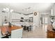 Bright kitchen boasts white cabinets, stainless steel appliances, granite countertops, and an island with seating at 18620 Rococo Rd, Spring Hill, FL 34610