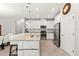 Modern kitchen featuring white cabinets, a granite island with seating, and stainless steel appliances for cooking at 18620 Rococo Rd, Spring Hill, FL 34610