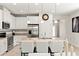 Modern kitchen featuring stainless steel appliances, granite countertops, island seating, and ample cabinet space at 18620 Rococo Rd, Spring Hill, FL 34610