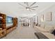 Open-concept living room with a TV, comfortable sofa, and view into the adjacent kitchen and dining area at 18620 Rococo Rd, Spring Hill, FL 34610