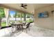 Enclosed patio with outdoor seating and ceiling fan, ideal for relaxing at 18620 Rococo Rd, Spring Hill, FL 34610