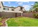 Green grassy backyard with a wooden fence, offering a private outdoor space at 1881 N Hercules Ave # 602, Clearwater, FL 33765