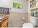 Bathroom with decorative tiling, natural-tone vanity, and neutral paint at 1881 N Hercules Ave # 602, Clearwater, FL 33765