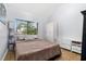 Cozy bedroom with ample storage, light wood floors, and a large window for natural light at 1881 N Hercules Ave # 602, Clearwater, FL 33765