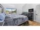 Bedroom with large window, dark wood furniture and neutral carpet at 1881 N Hercules Ave # 602, Clearwater, FL 33765