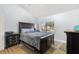 Bedroom featuring a dark wood bed set, window view, and neutral carpeting at 1881 N Hercules Ave # 602, Clearwater, FL 33765