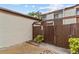 Charming courtyard entrance with a wooden gate leading to the townhome's private space at 1881 N Hercules Ave # 602, Clearwater, FL 33765