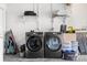 Garage features updated washing machines and dryer with storage shelves at 1881 N Hercules Ave # 602, Clearwater, FL 33765