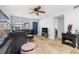 Well-lit living room featuring travertine floors, a comfortable grey sofa, and access to the rest of the home at 1881 N Hercules Ave # 602, Clearwater, FL 33765
