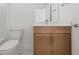 Bathroom featuring a toilet, sink, and vanity with cabinets at 303 15Th N St, St Petersburg, FL 33705