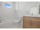 Bathroom with a toilet, tub, and vanity with storage cabinet at 303 15Th N St, St Petersburg, FL 33705