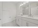 Modern bathroom featuring double vanity, white cabinets, and marble floors at 303 15Th N St, St Petersburg, FL 33705