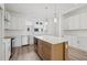 Bright, contemporary kitchen featuring white cabinets, stainless steel appliances, and a center island at 303 15Th N St, St Petersburg, FL 33705
