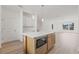 Bright kitchen featuring an island with a microwave, white cabinets, and hardwood floors at 303 15Th N St, St Petersburg, FL 33705