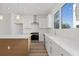 Contemporary kitchen with stainless steel appliances, white countertops, and a large window at 303 15Th N St, St Petersburg, FL 33705