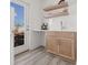 Wet bar area with cabinets, floating shelves, and open doorway to patio at 303 15Th N St, St Petersburg, FL 33705