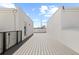 Roof top deck area with wood floors and surrounding walls and black railings at 303 15Th N St, St Petersburg, FL 33705