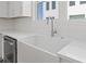 Close-up of a white farmhouse sink with stainless steel faucet and modern countertops at 303 15Th N St, St Petersburg, FL 33705