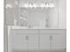 Elegant bathroom featuring a double vanity, a large mirror, and modern lighting for a luxurious experience at 321 15Th N St, St Petersburg, FL 33705