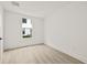 Minimalist bedroom with a large window, light hardwood floors, and neutral paint create a calming atmosphere at 321 15Th N St, St Petersburg, FL 33705