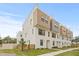 Modern three-story townhome showcases a contemporary design with neutral colors and manicured landscaping at 321 15Th N St, St Petersburg, FL 33705
