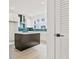 Stylish kitchen boasting a dark island, white cabinetry, stainless steel appliances and green backsplash at 321 15Th N St, St Petersburg, FL 33705