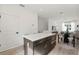 Modern kitchen island with white countertop, dark cabinets, and seating at 321 15Th N St, St Petersburg, FL 33705