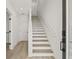 Bright entryway features a contemporary staircase with hardwood floors and a white railing at 321 15Th N St, St Petersburg, FL 33705